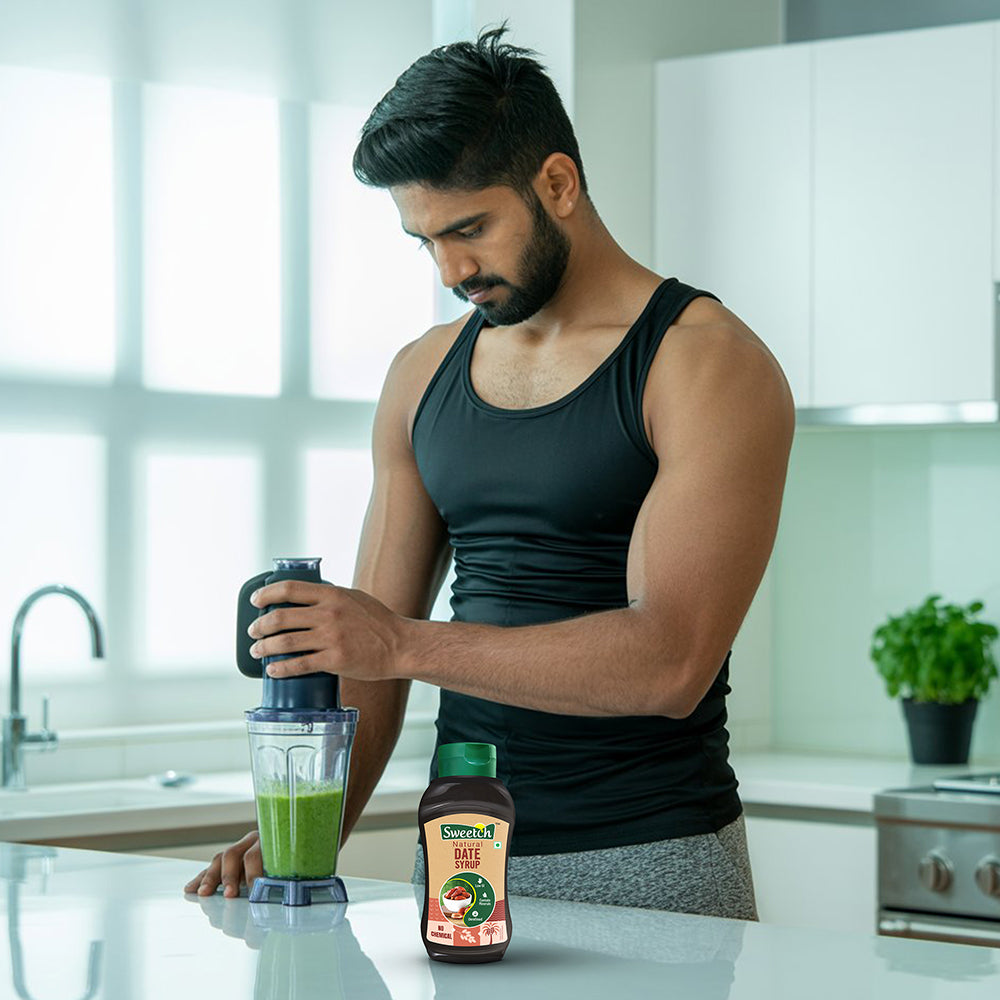 Man preparing a smoothie in a kitchen using date syrup.