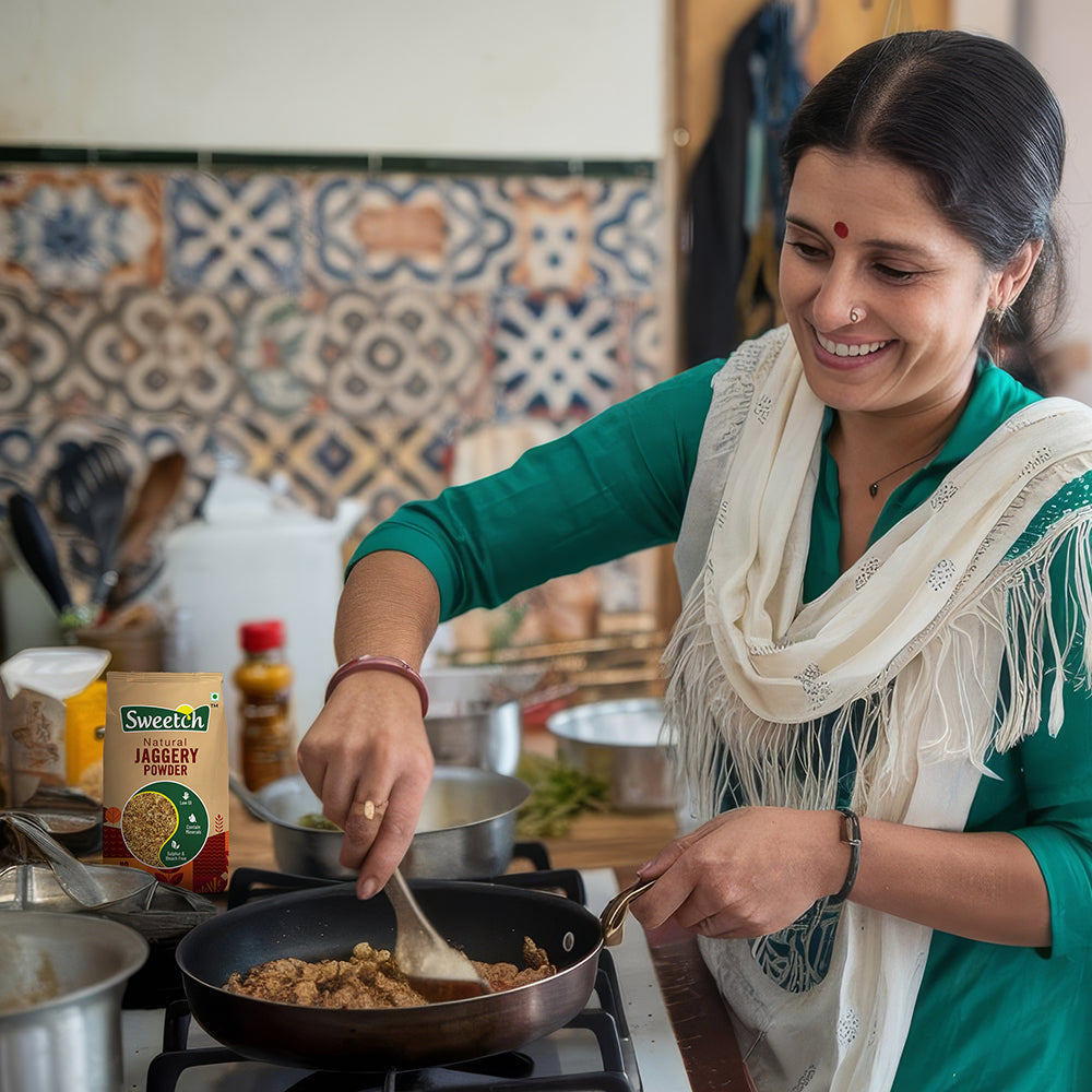 Woman cooking in a kitchen with a using Swetch Jaggery Powder